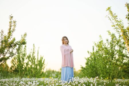 Girl in a flowering gardenの写真素材