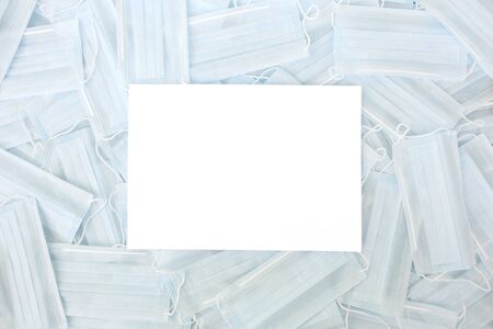 Medical hygienic mask, Face protective masks on blue background.Disposable surgical face mask protective against Coronovirus Covid-19,pollution, virus, flu.Healthcare medical surgical Flat lay patternの写真素材