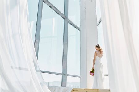 Fashion bride in gorgeous wedding dress. Beautiful model with bridal makeup and hairstyle in marriage dress.の写真素材