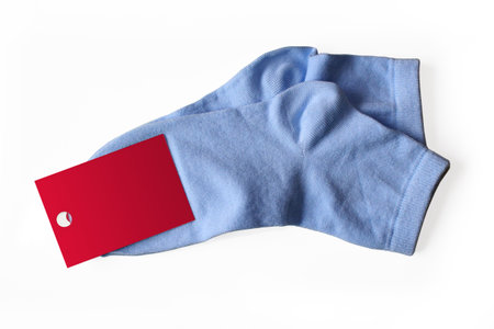 New thin blue socks with a label isolated on white background.の写真素材