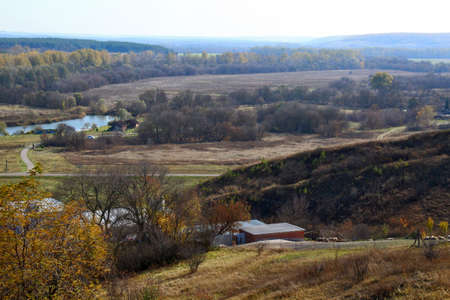 Autumn landscape with fields and trees.