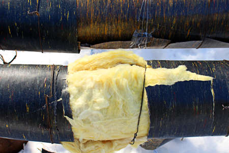 Yellow insulation material around the pipe with hot tap water.の写真素材