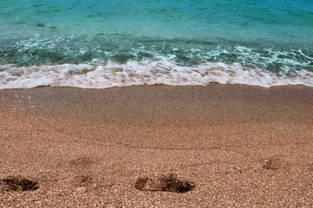 Blue sea wave on a pebble beach.の写真素材