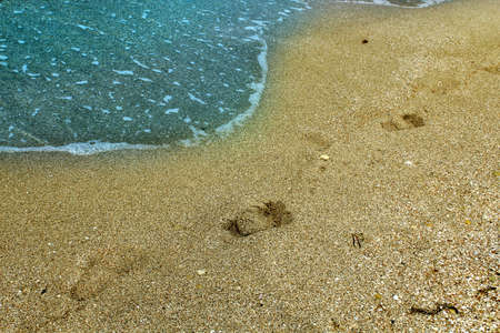 Blue sea wave on a pebble beach.の写真素材