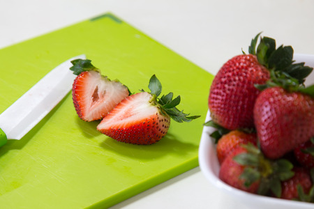 A Bowl and Slices of Strawberriesの写真素材