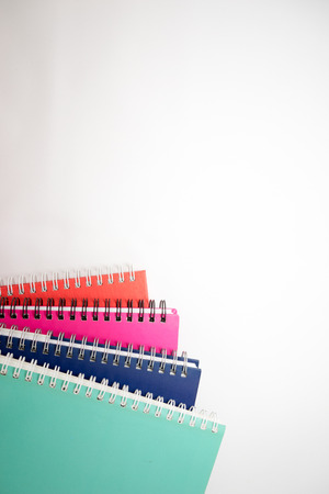 A few stacked notebooks isolated on white background