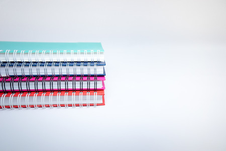 A few stacked notebooks isolated on white backgroundの写真素材