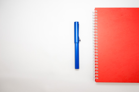 Notebook and pen isolated on white backgroundの写真素材