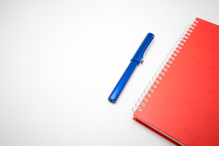 Notebook and pen isolated on white background