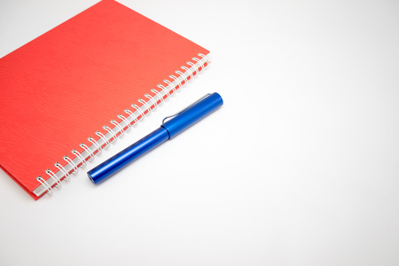 Notebook and pen isolated on white backgroundの写真素材
