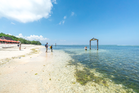 Tropical sandy beach with buildings and boats in a sea. Gili Trawangan, Indonesiaのeditorial素材