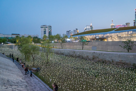 Seoul, Korea - May, 2016: LED lit roses and Dongdaemun Design Plaza, designed by the famous architect Zaha Hadid in Seoul, South Korea.のeditorial素材