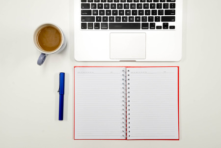 Flat lay photo of white office desk with laptop keyboard, top viewの写真素材
