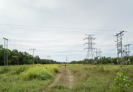 Man of maintenance patrol and inspect transmission power line tower