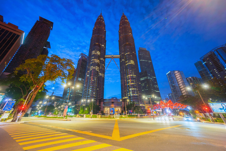 Kuala Lumpur, Malaysia - September 24, 2016: Road junction at Suria Klcc with Petronas Twin Towers and Office Buildings at Blue Hour and rush hour morning.のeditorial素材