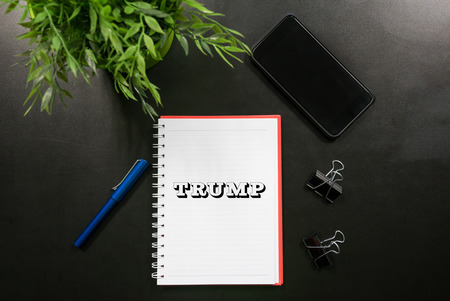 Kuala Lumpur, Malaysia - November 9, 2016: Word Trump with flat lay office concept. Donald Trump is...