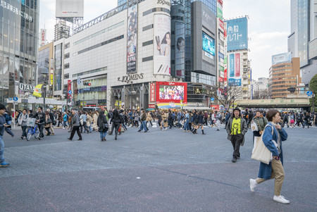 Tokyo, Japan - April 3, 2017: Pedestrians cross at Shibuya Crossing. It is one of the world's most famous and claim to be a busiest scramble crosswalks.のeditorial素材