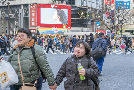 Tokyo, Japan - April 3, 2017: Pedestrians cross at Shibuya Crossing. It is one of the world's most famous and claim to be a busiest scramble crosswalks.のeditorial素材