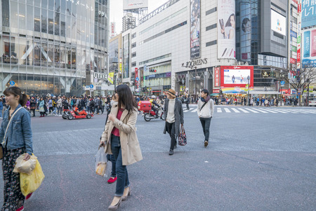 Tokyo, Japan - April 3, 2017: Pedestrians cross at Shibuya Crossing. It is one of the world's most famous and claim to be a busiest scramble crosswalks.のeditorial素材