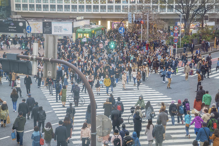 Tokyo, Japan - April 3, 2017: Pedestrians cross at Shibuya Crossing. It is one of the world's most famous and claim to be a busiest scramble crosswalks.のeditorial素材