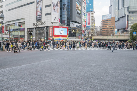 Tokyo, Japan - April 3, 2017: Pedestrians cross at Shibuya Crossing. It is one of the world's most famous and claim to be a busiest scramble crosswalks.のeditorial素材