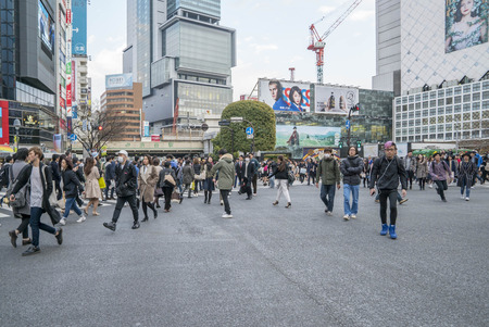 Tokyo, Japan - April 3, 2017: Pedestrians cross at Shibuya Crossing. It is one of the world's most famous and claim to be a busiest scramble crosswalks.のeditorial素材