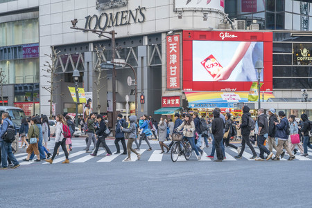 Tokyo, Japan - April 3, 2017: Pedestrians cross at Shibuya Crossing. It is one of the world's most famous and claim to be a busiest scramble crosswalks.のeditorial素材