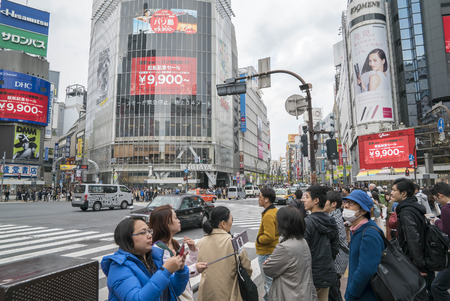 Tokyo, Japan - April 3, 2017: Pedestrians cross at Shibuya Crossing. It is one of the world's most famous and claim to be a busiest scramble crosswalks.のeditorial素材