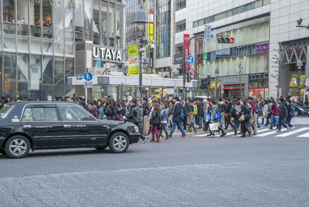 Tokyo, Japan - April 3, 2017: Pedestrians cross at Shibuya Crossing. It is one of the world's most famous and claim to be a busiest scramble crosswalks.のeditorial素材