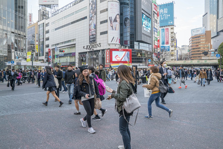 Tokyo, Japan - April 3, 2017: Pedestrians cross at Shibuya Crossing. It is one of the world's most famous and claim to be a busiest scramble crosswalks.のeditorial素材