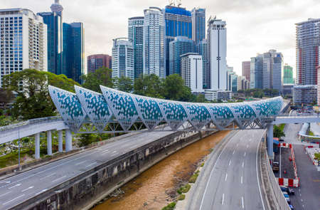 Kuala Lumpur, Malaysia - February 22, 2020 : Aerial drone view of newly opened pedestrian bridge...
