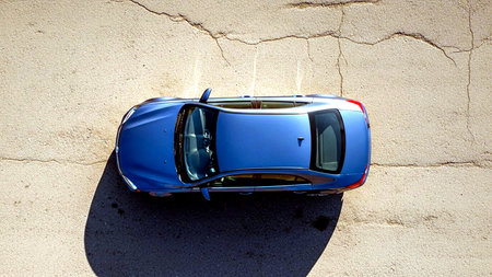 Blue car on the background of a stone wall. View from above.の素材