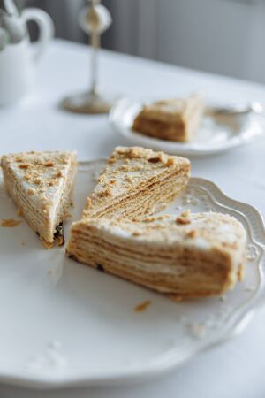 three pieces of beige cake on a white plate on a white table