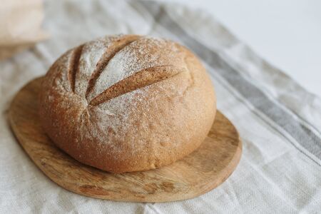 Sliced bread on a board on a white tablecloth