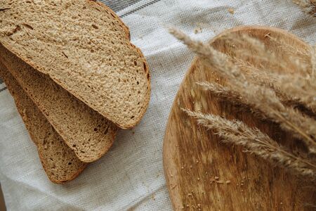 Sliced bread on a board on a white tablecloth