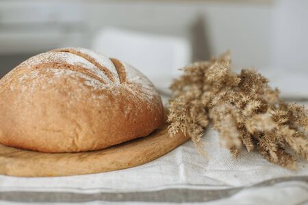 Sliced bread on a board on a white tableclothの写真素材
