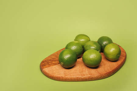 Lots of green, juicy limes on a green background in full screen.の写真素材