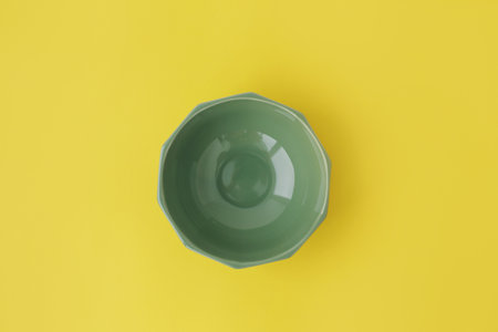 A gray, beautiful plate in the center, on a yellow background, full screen.の写真素材