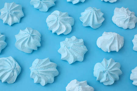 A lot of beautiful, colored meringues on a colored background in full screen.の写真素材