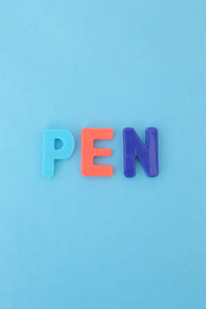 Lots of colored, magnetic letters on a full screen colored background.の写真素材