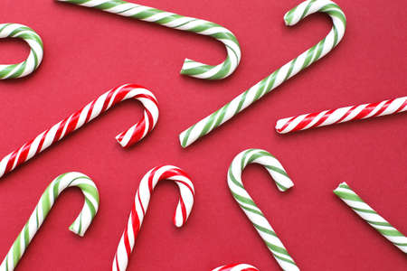 Delicious, whole Christmas candy canes on a bright, full-screen background.の写真素材