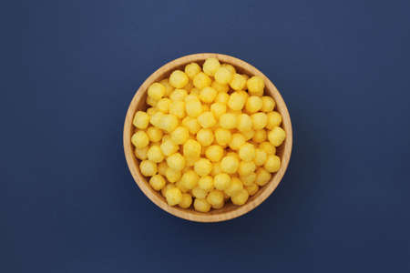 Cheesess balls and snacks, in large amounts of quantities, even backgrounds.