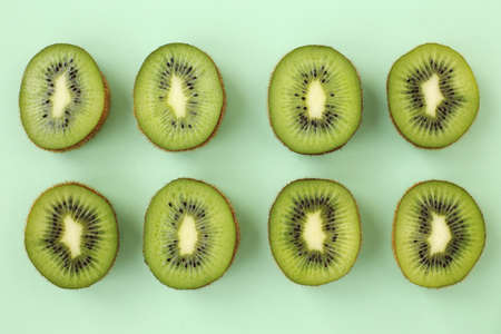 Juicy, tasty kiwi slices. They lie on a bright, light, colored background.