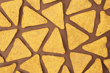 Corn, yellow, salty snacks on a bright, even, light background.
