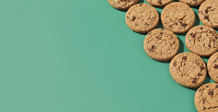 Delicious oatmeal chocolate chip cookies. They lie on an even and colored background.の写真素材