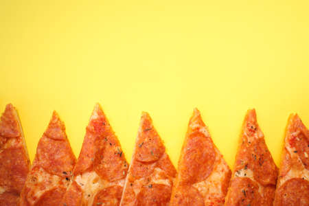 Delicious and fresh pepperoni pizza. Lies on a bright and even background in full screen.