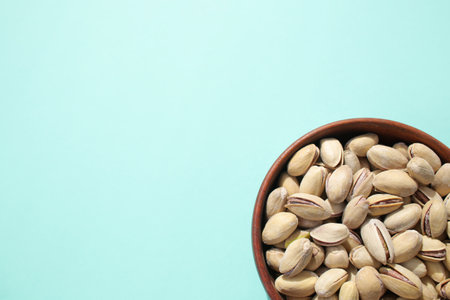 Roasted, salted, fresh pistachios on a bright, colorful background.
