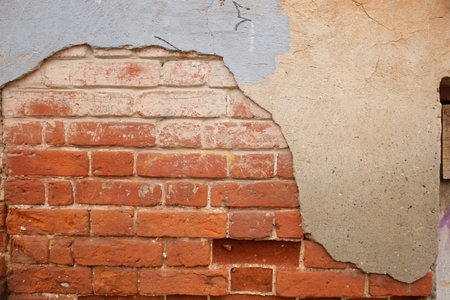 An old, shabby brick wall in full screen. With elements of old age and destruction of the wall.の写真素材