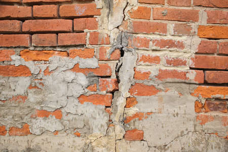 An old, shabby brick wall in full screen. old building.
