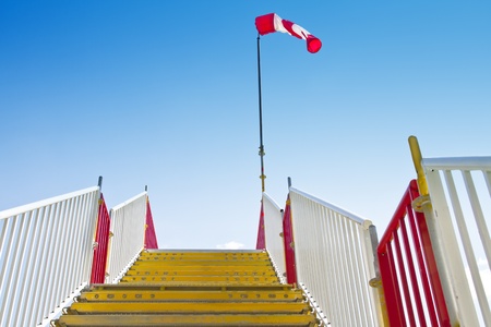 Yellow stairway with inflated windsock on its peak.の写真素材